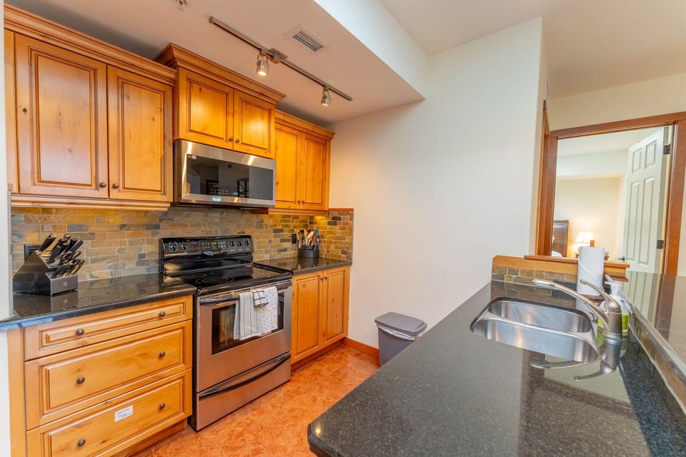 Kitchen with wooden cabinets, stainless appliances, and counter space