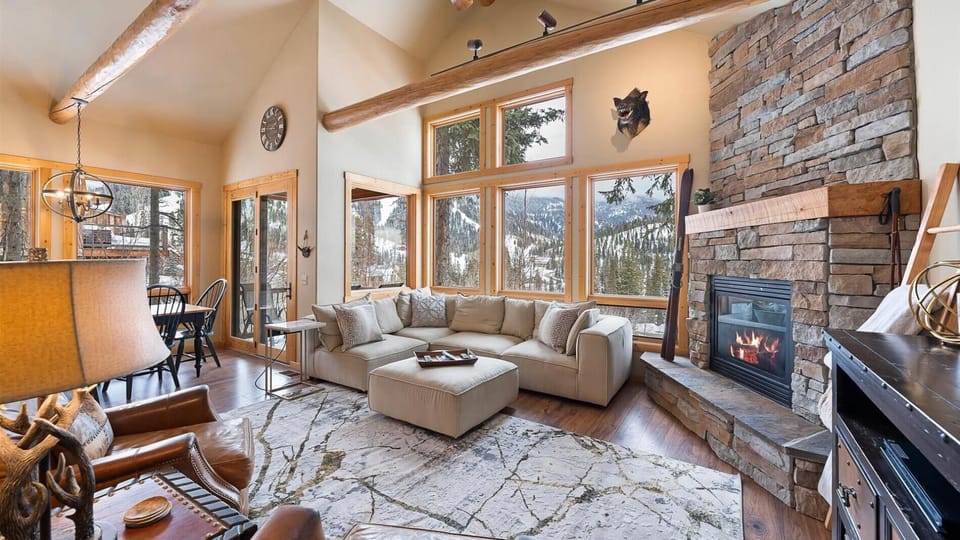 Luxurious open concept living room with gas fireplace, HDTV with streaming capabilities, and unparalleled alpine views of Whitefish Mountain Resort