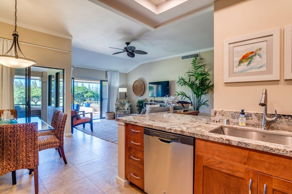 Sun-filled open layout connects kitchen, dining, and living spaces for effortless island living.