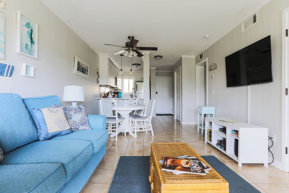 Living Room with sofa bed, 50" Roku Smart TV, and dining area