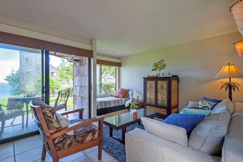 Sealodge F1 | ocean view living room | Sealodge Princeville Kaua - Curl up on the punee in the window and watch the waves from the comfort of your living room!