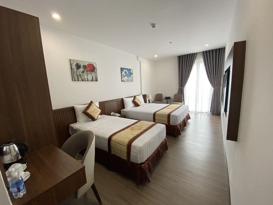 Deluxe Triple Room, City View | Minibar, in-room safe, desk, blackout drapes
