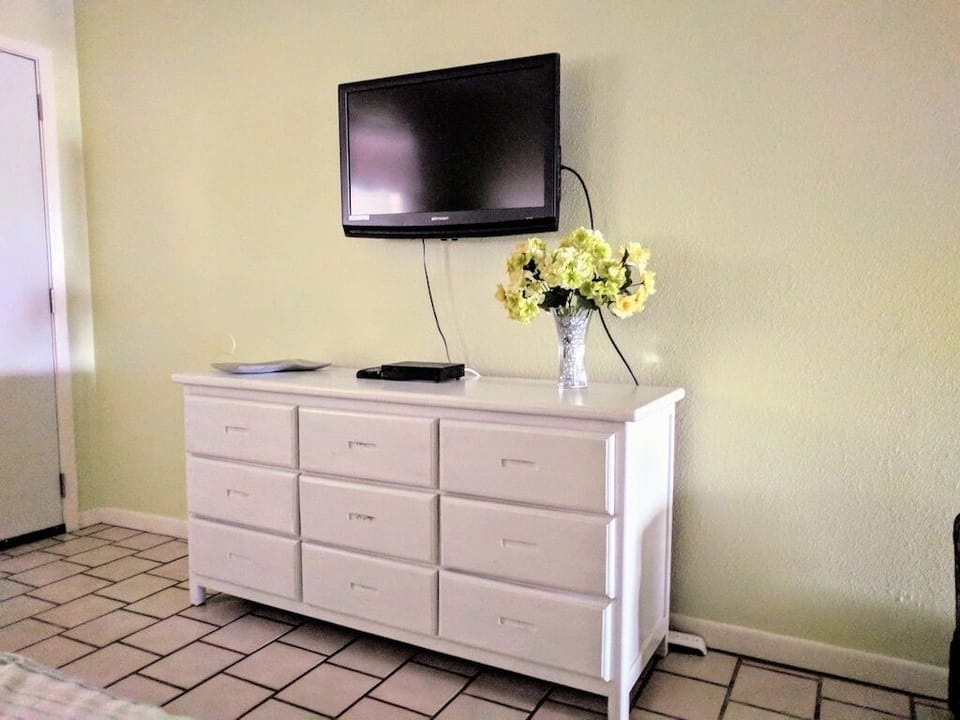 Mounted TV and a small dresser to store your essentials.