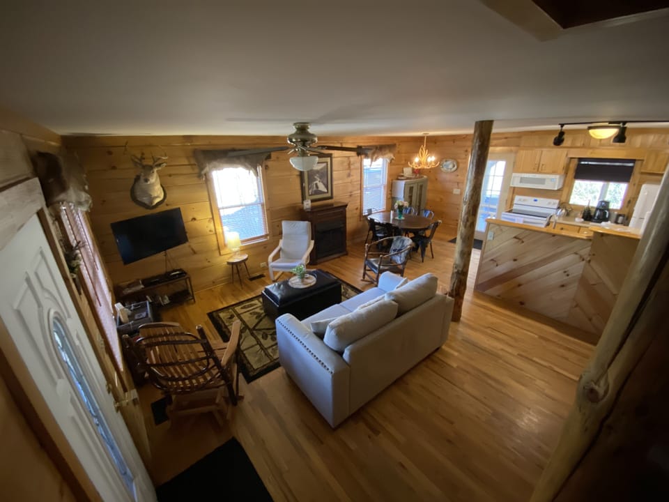 View of living are and kitchen with new couch and table
