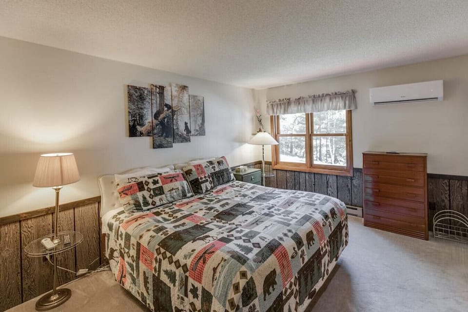 Master bedroom with neutral tones and hardwood flooring