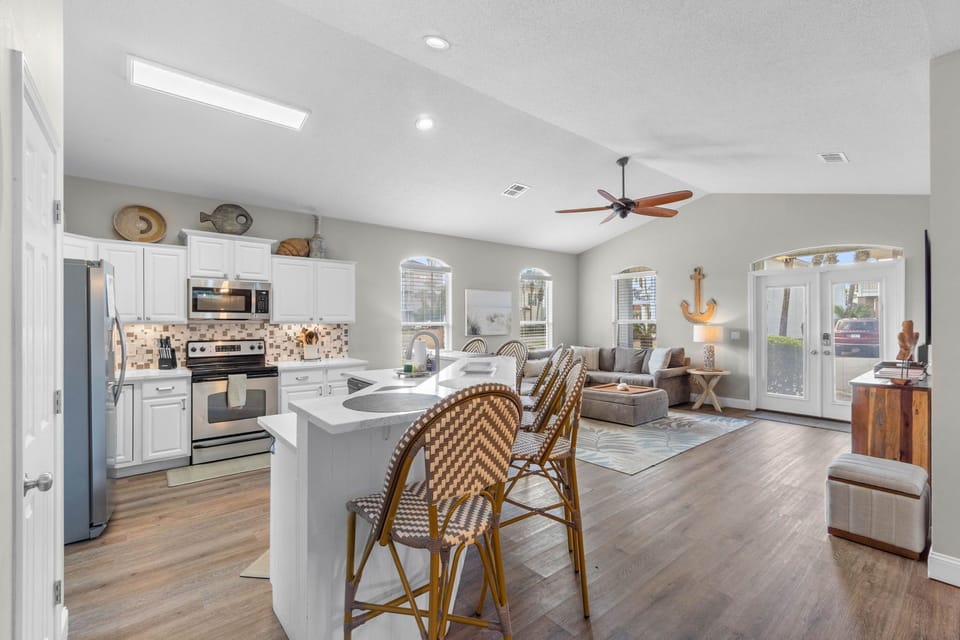 Bright open-concept kitchen and living area with stylish island seating