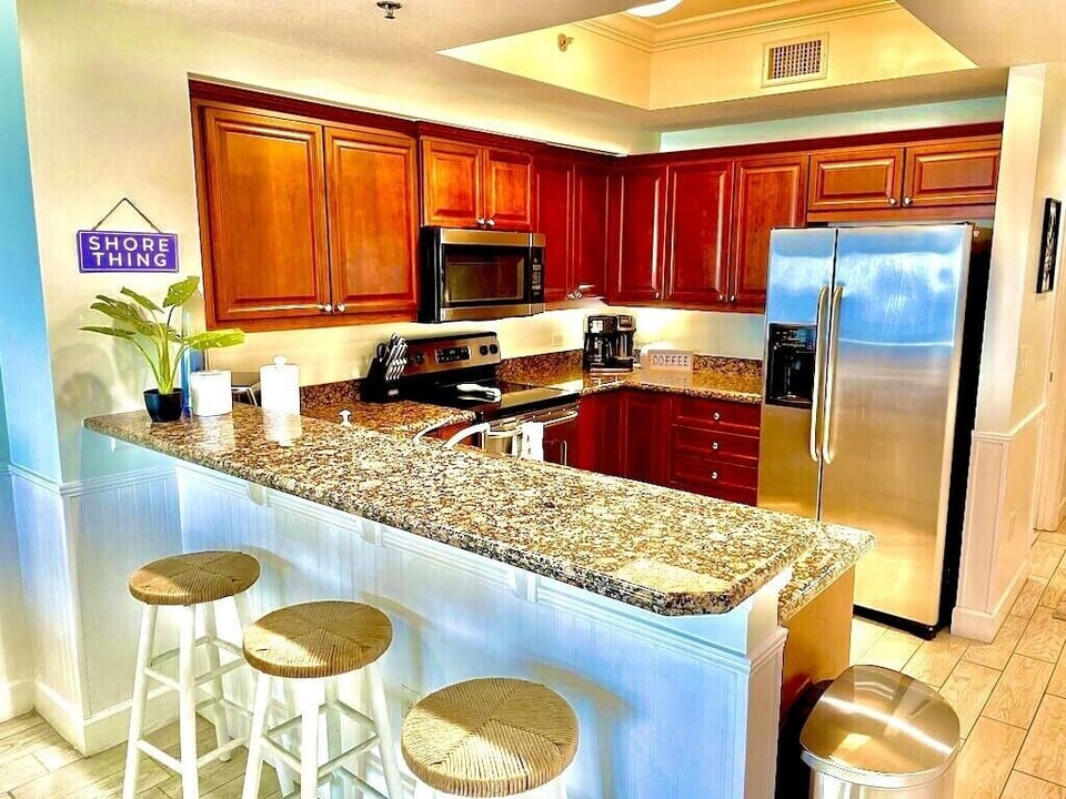 Full kitchen with barstools for extra seating. 