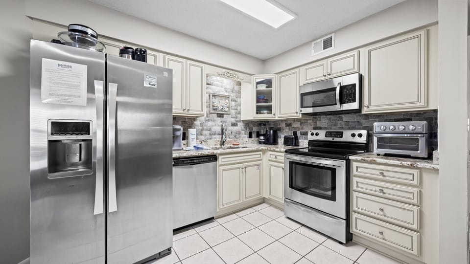 Sandpiper 4B - Fully equipped kitchen with stainless steel appliances, refrigerator with ice maker, coffee maker, and toaster for easy meal preparation.
