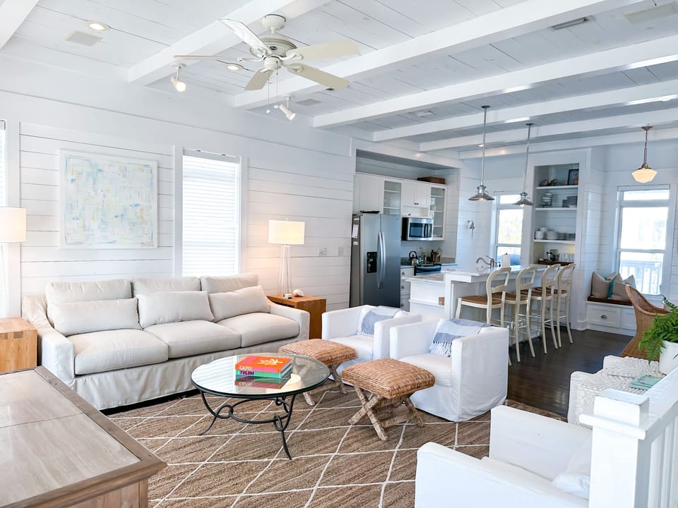 Open concept living room, dining and kitchen area with TV and beach / ocean view