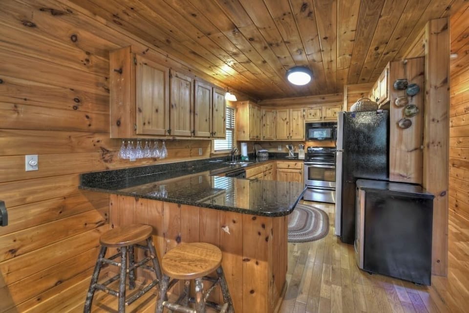 Fully stocked kitchen with granite countertops and stainless steel appliances