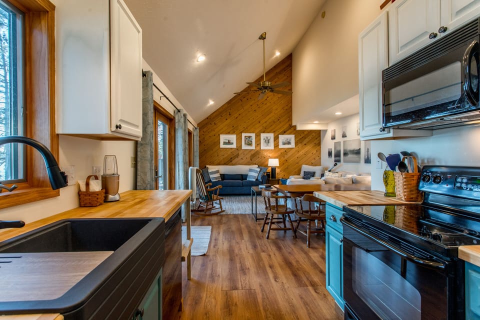 Newly updated kitchen has a farmhouse sink, new fixtures, butcher block counters
