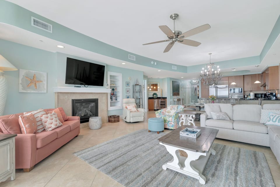 The spacious, elegantly decorated living area features two Queen-sized pull-out sofas within the plush seating arrangement, providing incredibly flexible accommodations for extra guests. This comfortable space is perfect for relaxing by the fireplace or en