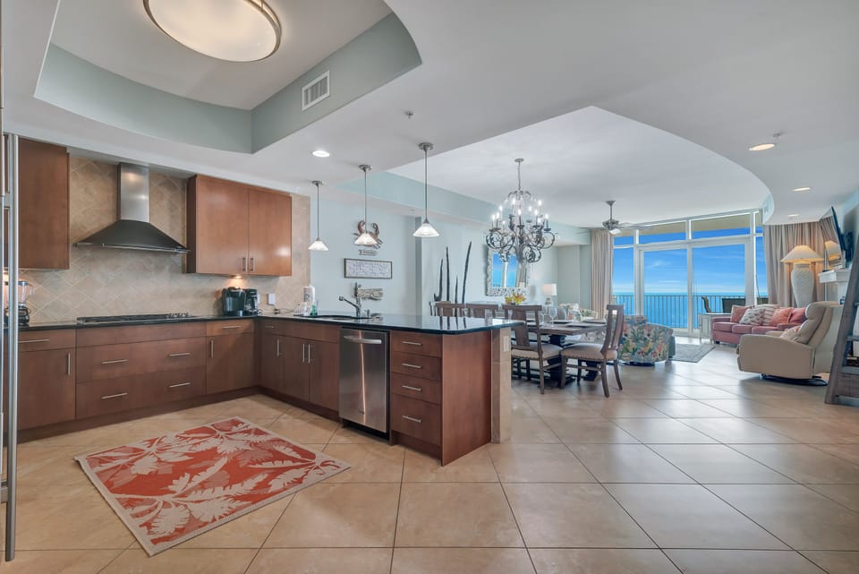This gourmet kitchen features sleek granite countertops, stainless steel appliances, and ample cabinet space, all while offering breathtaking Gulf views that make every meal a memorable experience.