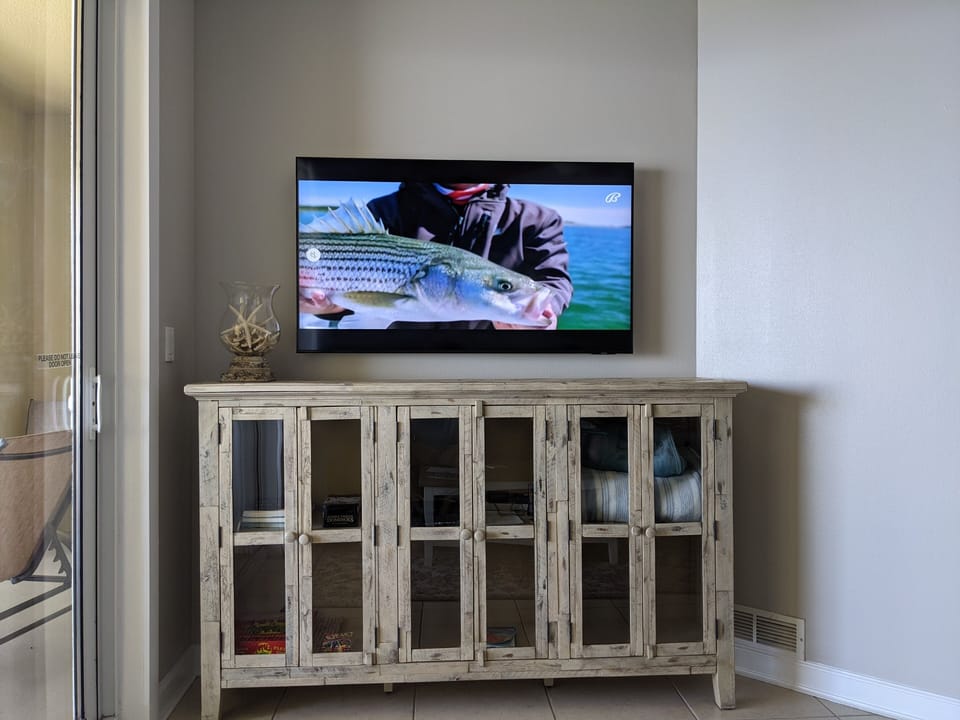 Enjoy watching tv in the living room on our new 55" UHD Smart Samsung tv.