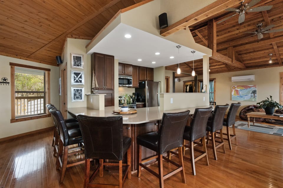 Kitchen counter seats 8 people (popular social space). Half-bath near window