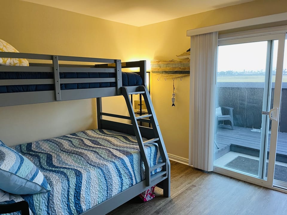 Twin and full bunk bed with access to the deck and views of the estuary. 