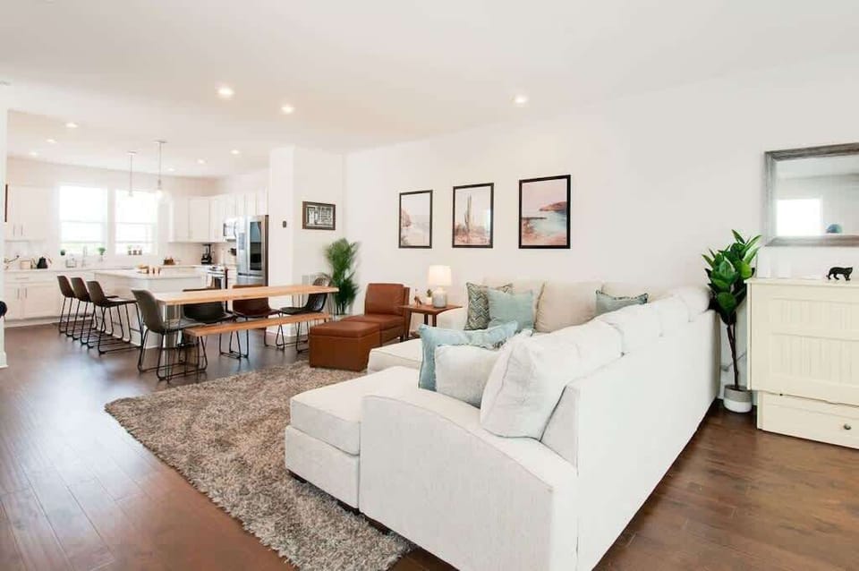 Relax and gather in a bright open-concept space connecting the living room, dining area, and kitchen for easy entertaining.
