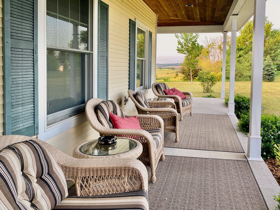 Farmhouse-style front porch facing the sunset