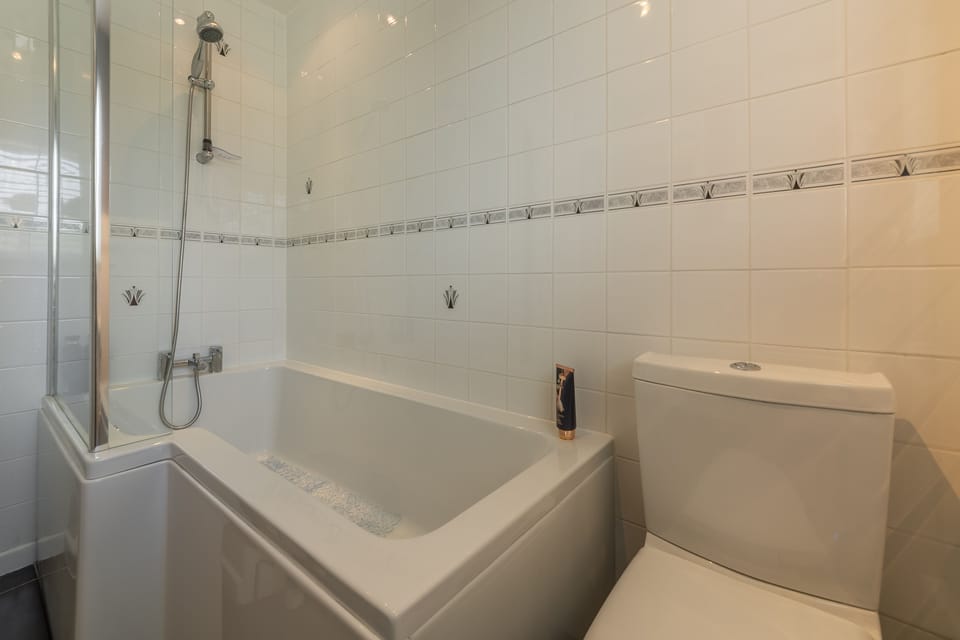 First floor: Family bathroom with bath and shower over head