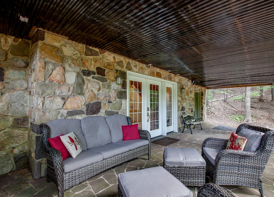 Lower level stone patio is a cozy place for morning coffee or evening beverages.