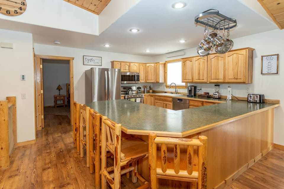 Well-stocked kitchen with coffee maker.