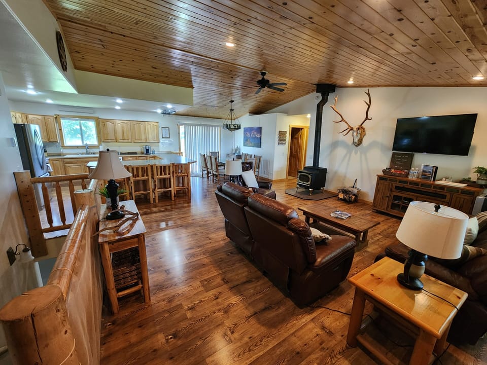 Open floor plan with large, well stocked kitchen, living room and dining table.