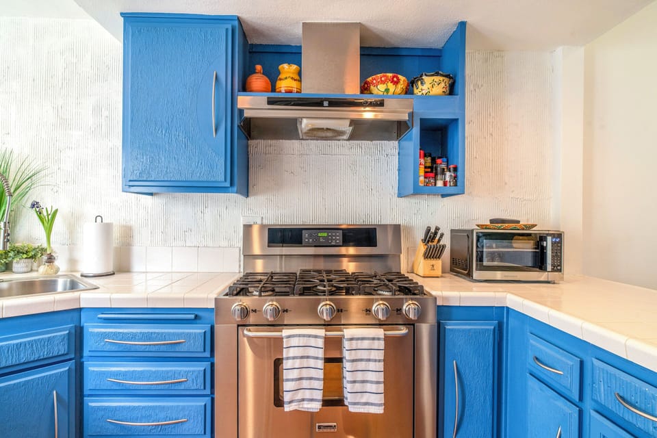 Upgraded kitchen with custom cabinetry and gas range
