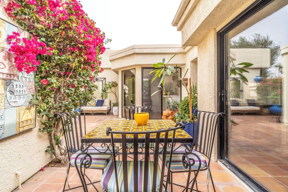 Private landscaped courtyard with seating and outdoor dining