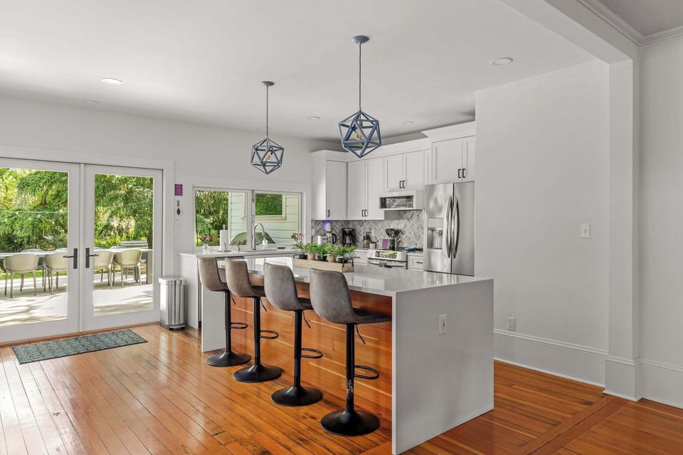 Fully equipped gourmet kitchen with island seating and easy access to outdoor entertaining spaces.