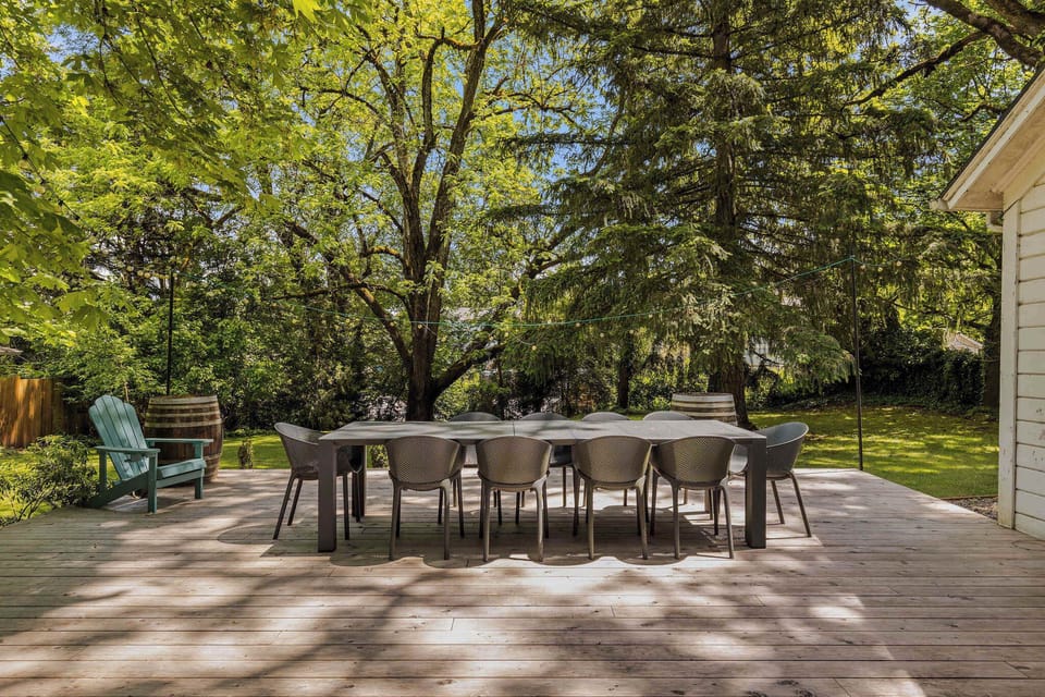 Dine al fresco beneath towering trees on this spacious private entertaining deck.