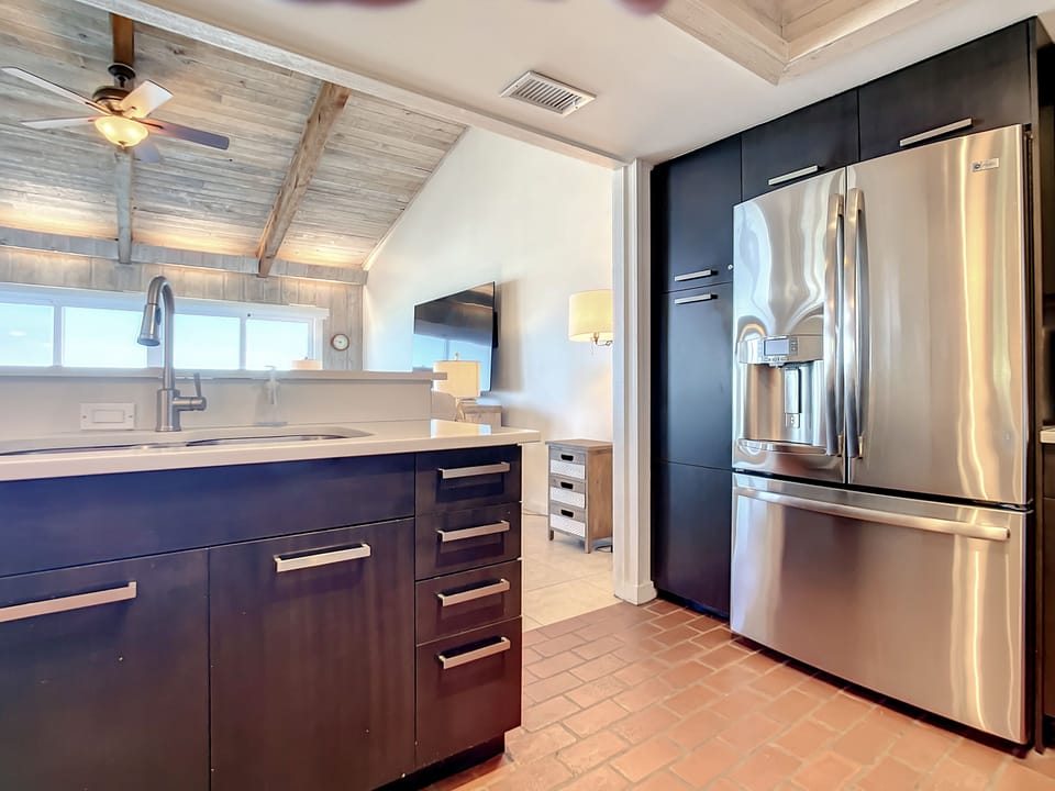 Stainless steel refrigerator with ice and water dispenser.