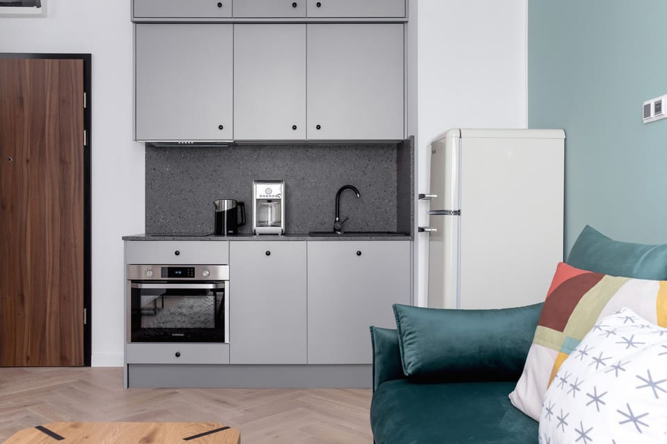 The sleek design of the kitchenette blending seamlessly with the living area.