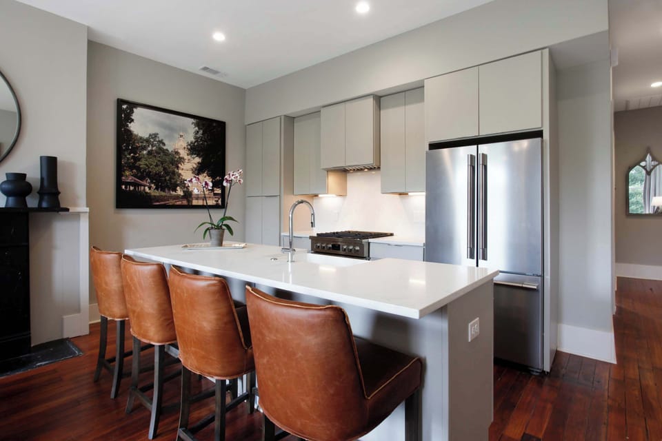 Kitchen | Kitchen with Stainless Steel Appliances and Bar Seating | Fourth Floor of Building — Unit on One Level