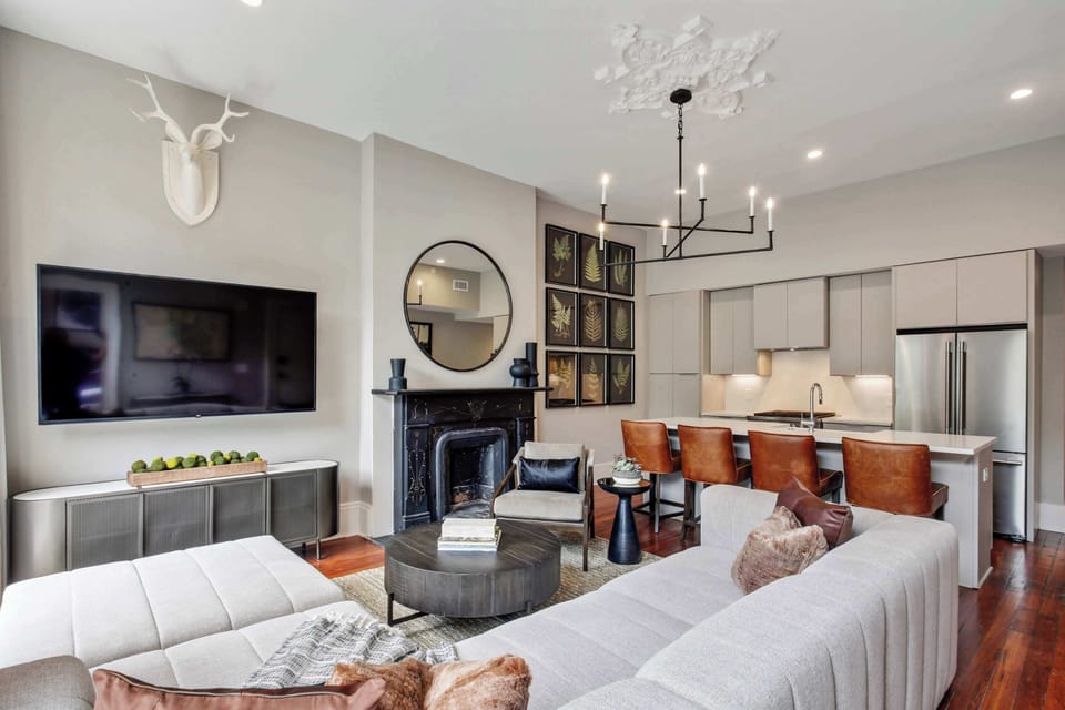 Living Room | Open Concept Layout with TV and Fireplace | Third Floor of Building — Unit on One Level