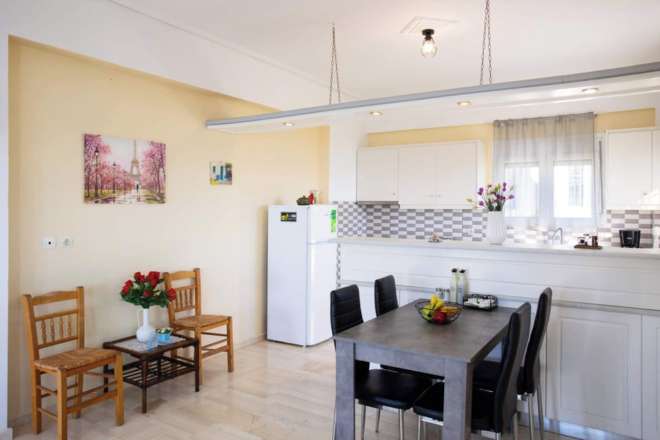 Dining Table and Fully Equipped Kitchen Area
Dining table next to a fully equipped kitchen with essential appliances.