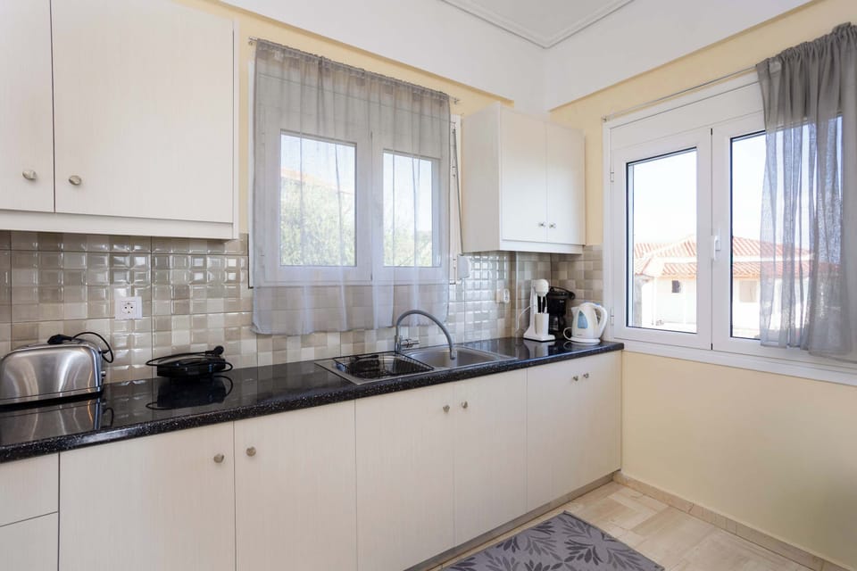 Fully equipped kitchen with oven, fridge, and cooking essentials