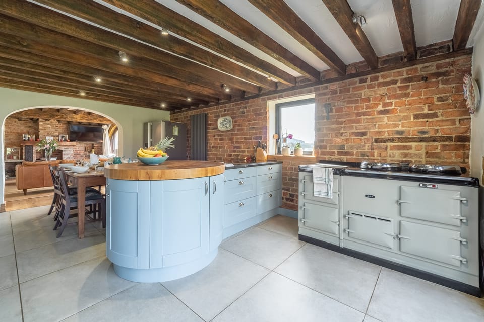 Ground floor: Kitchen with island unit and duck egg blue, four oven Aga