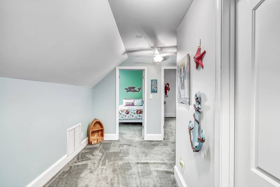 Adventure awaits at the top of the stairs! 🚀🌴 Step into our cozy upstairs landing, where excitement and fun are just around the corner. With the bathroom on the right and the kids' bedrooms straight ahead, the perfect family getaway begins here.