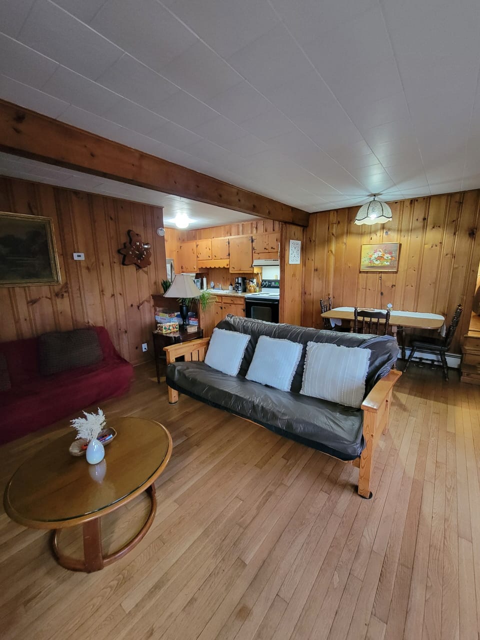 Living room with dining area, two futons. Brown futon turns into full size bed. 