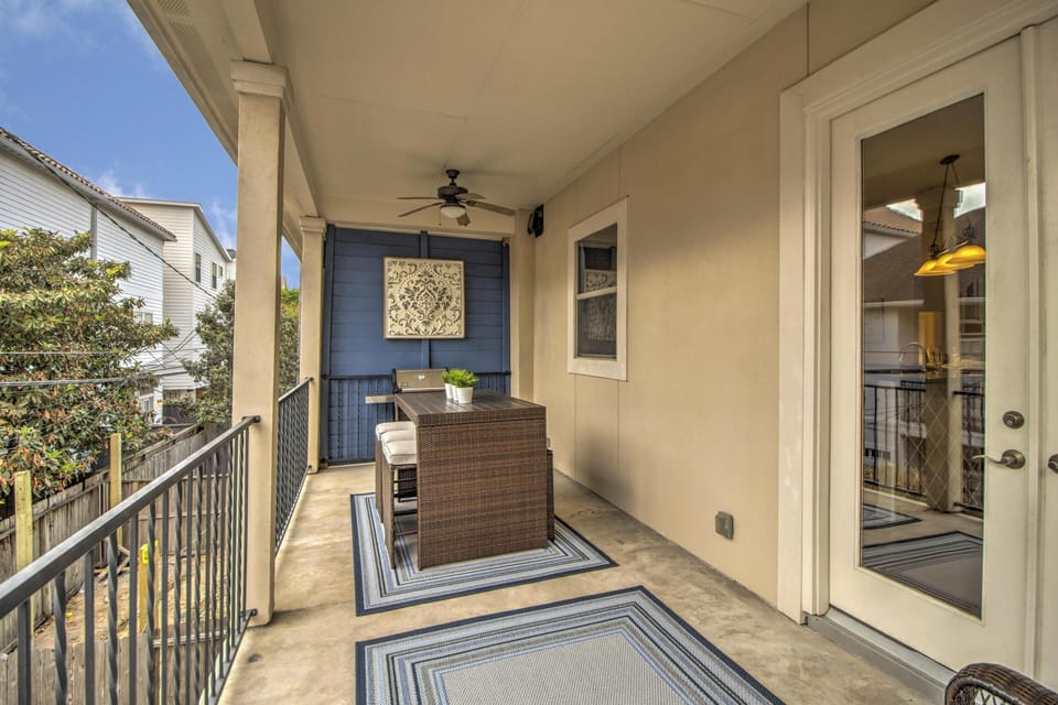 Second floor outdoor space with sofa, counter seating and new grill