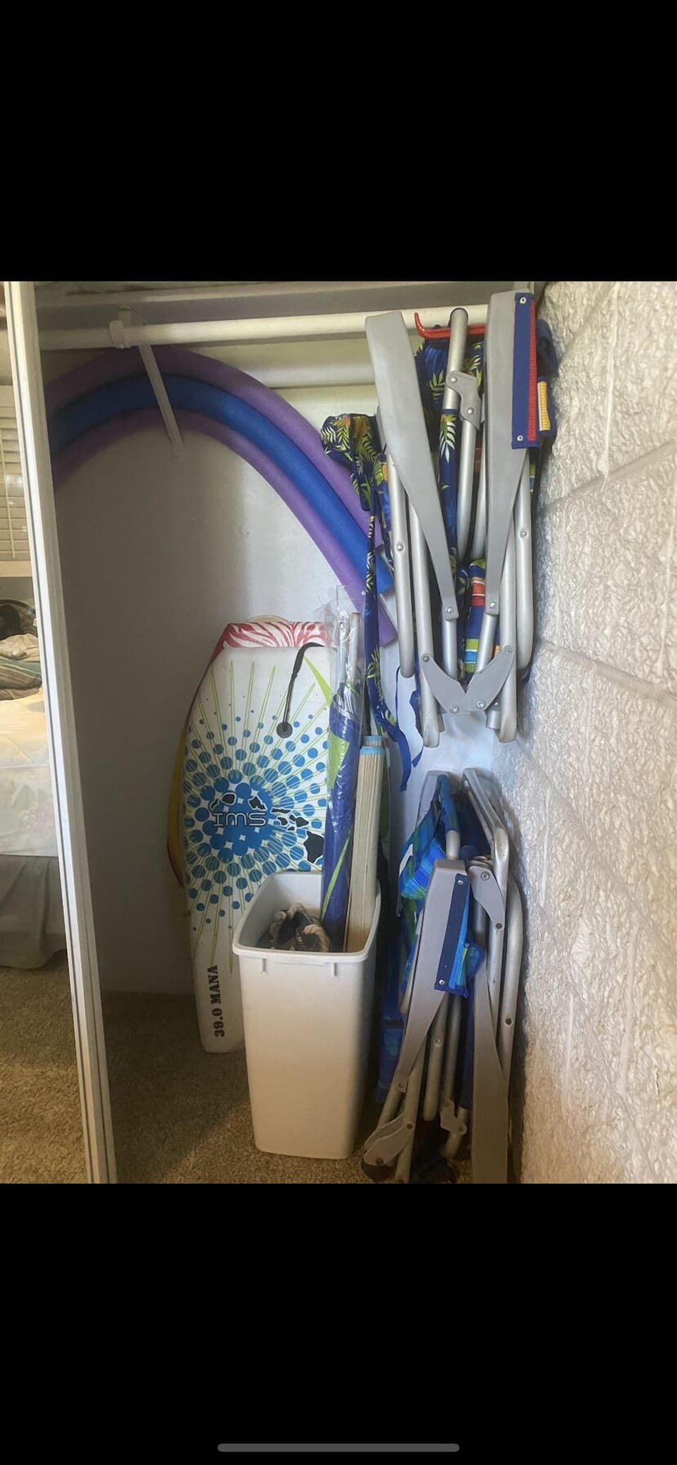 Guest Bed closet with 4 Beach chairs, umbrella and more, toy box in living room