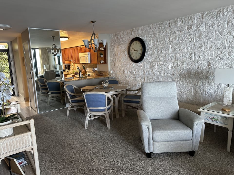 Dining area with ample room for four — enjoy meals with ocean views.