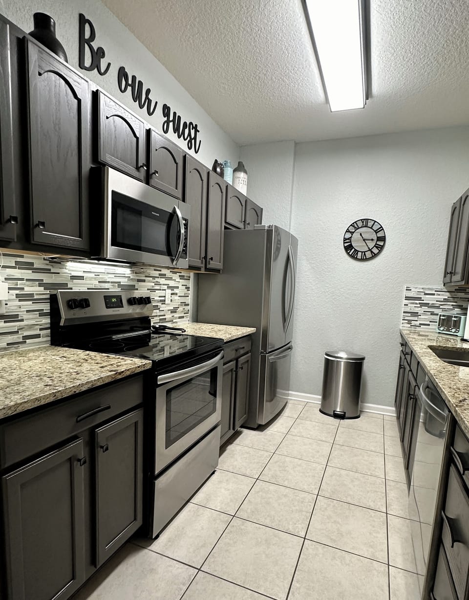 Kitchen with Granite & Stainless Steel Appliances.