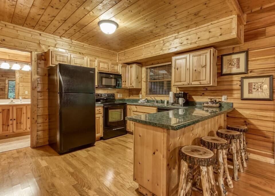Keurig with coffee pot, seating for four at the counter.