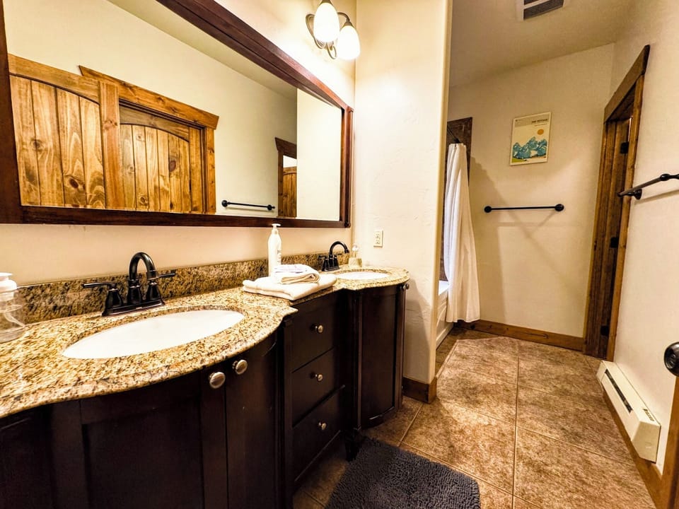 Ensuite bathroom — double vanity plus a full tub/shower combo.
