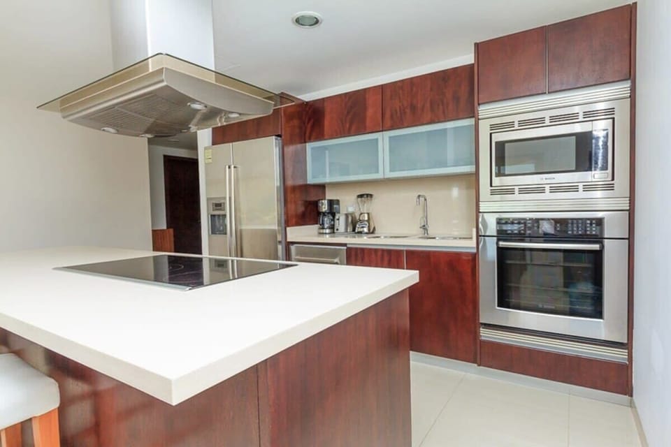 Modern kitchen with stainless steel appliances and a large island cooktop
