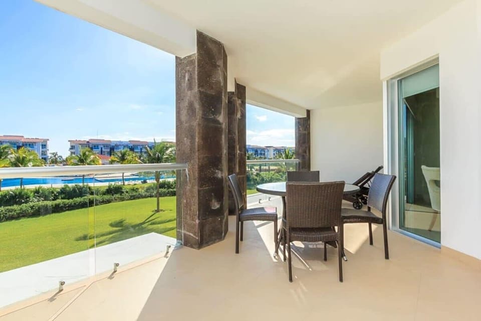 Spacious balcony with outdoor dining and garden views for relaxing meals.