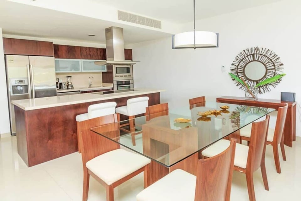 Modern kitchen and dining area with glass table and wooden accents