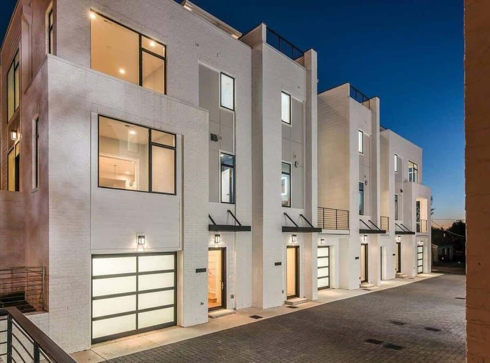Exterior of condos with view of courtyard and garages