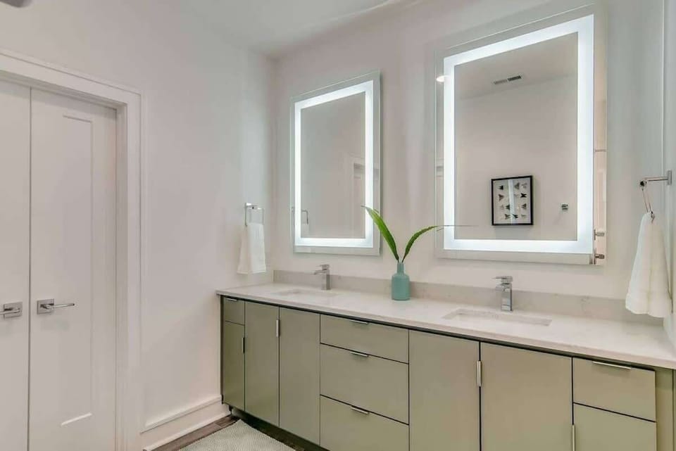 Master bathroom with huge shower and double lighted mirrors.